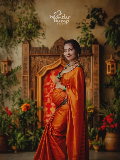 This stunning portrait is part of our Ravi Varma-inspired series. The rich colors, traditional attire, and artistic set design come together to create a photo that looks like a classic painting.