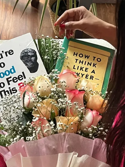 A close-up of the book bouquet, featuring "How to Think Like a Lawyer." It is a reminder that learning is a continuous journey, and there is always a new perspective to discover.