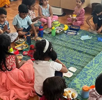Children enjoying a community snack during our Holi celebration, a time for sharing and togetherness.