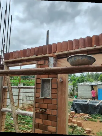 A view of the construction site, showing the exposed brick walls and wooden formwork.