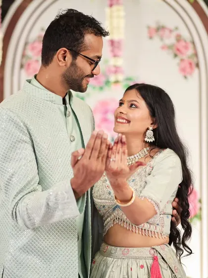 A candid shot of an engaged couple sharing a happy, interactive moment.