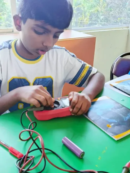 Getting comfortable with diagnostic tools is a key part of our curriculum. This student is learning the functions of a multimeter to check their circuit's performance.