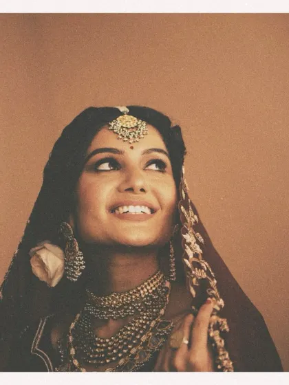 A portrait that feels like a timeless painting. For this campaign, we embraced a vintage aesthetic, using warm, earthy tones and soft lighting to highlight the bride's joyful expression. The layered polki and pearl jewelry and the rich maroon ensemble were curated to evoke a sense of old-world, regal charm.