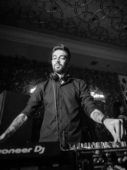 A moody, black and white photo showing me at work. My style is modern and clean, and I bring that aesthetic to my DJ setup.