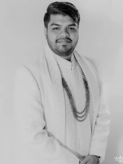 A classic black and white portrait of the groom, looking dapper and ready for his big day. These timeless shots are a must-have in any wedding album.