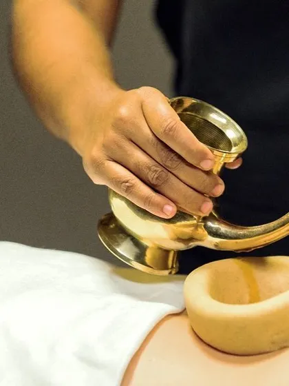This is Kati Basti, one of our most effective treatments for chronic back pain and sciatica. A dam of herbal dough holds warm, medicated oil over the lower back, deeply nourishing the nerves and relieving stiffness.