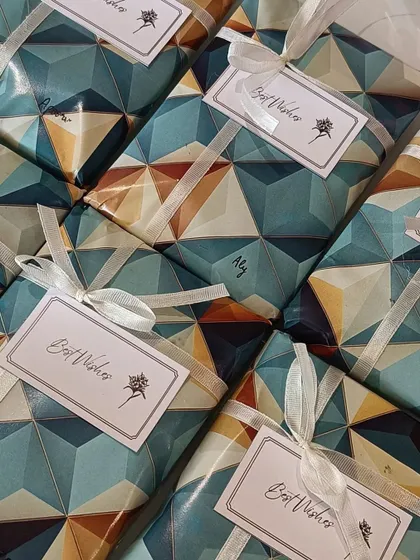 An angled view of the geometrically wrapped gifts, showcasing the consistent and professional presentation for a bulk order.