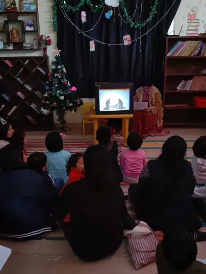 A duplicate of image 297, showing the audience captivated by the nativity story.