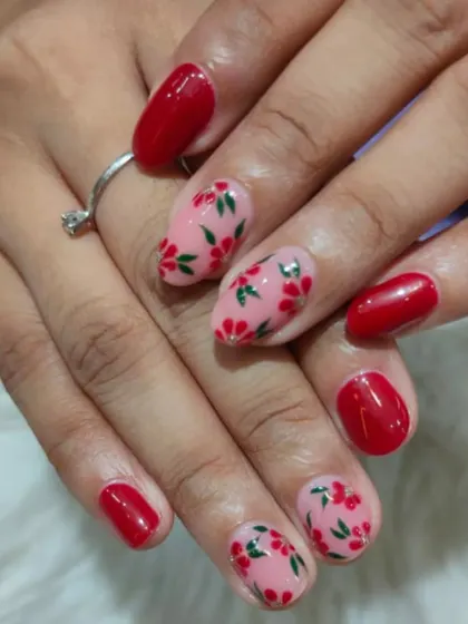 A sweet and delicate floral design, with tiny red flowers and green leaves hand-painted on a soft pink base.