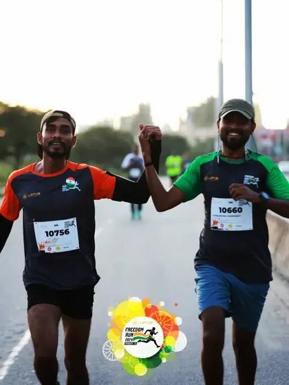 A moment of solidarity between two runners during the marathon, showcasing the supportive spirit of the running community.
