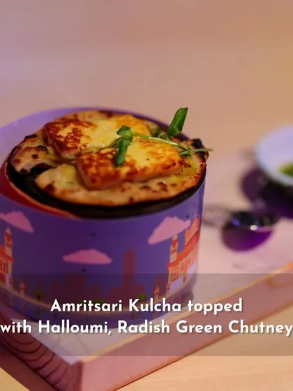 Another view of the Amritsari Kulcha dish, served in a custom-branded container.