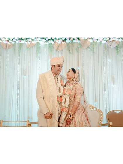 A quiet moment for the couple on stage, taking in the reality that they are finally married. Their shared look says it all.