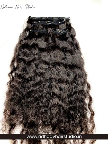 A full view of one of the pieces from our 4-piece curly clip-in set. Made from 100% real human hair, these extensions have a natural bounce and texture.