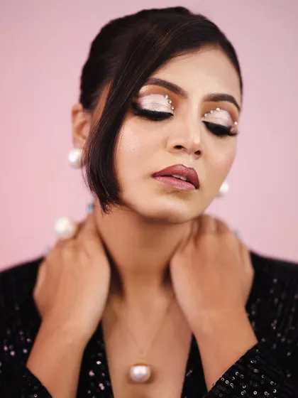 A close up showing the detailed crystal work on the eyes. This is a great example of editorial-style makeup that can be adapted for a bold party look.