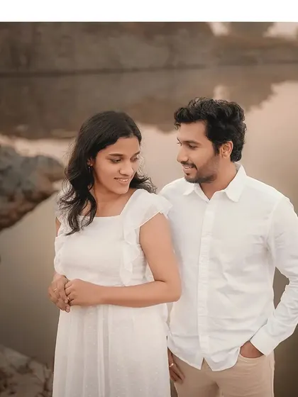 A sweet and simple portrait of the couple by the water. Their gentle smiles and relaxed posture show the comfortable love they share.