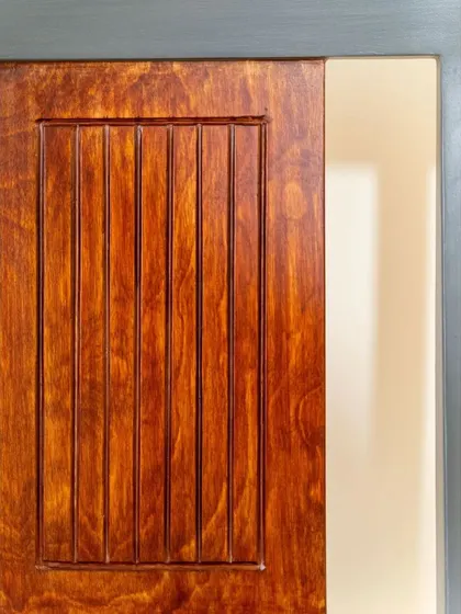A detail of the wood and grey finish on a custom study chair.