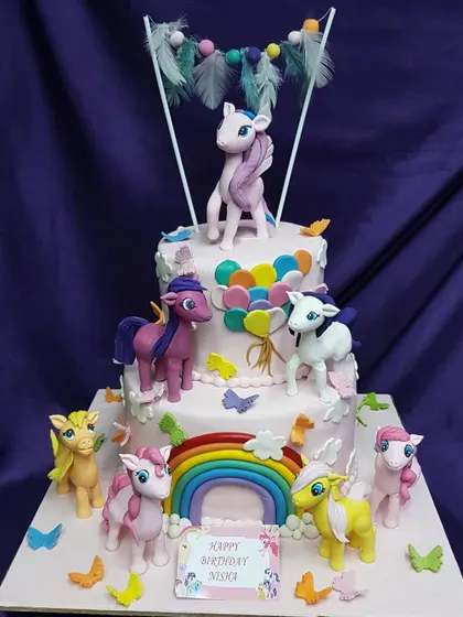 Friendship is magic, and so is this cake. A two-tier "My Little Pony" creation featuring a rainbow and all the main characters, perfect for a colorful and enchanting birthday party.