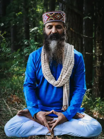 In the quiet of the forest, I find my deepest connection. Here, I am seated in meditation, a practice that is the foundation of all my teachings. It is in these moments of silence that we can truly listen to our inner voice.