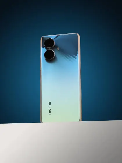 Another angle of the realme 10 Pro+ 5G on a white block, showcasing its slim profile.