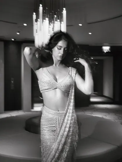 Disha Patani styled in a shimmering, pre-draped saree by Ritika Mirchandani. This look is a masterclass in modern ethnic wear, combining the elegance of a saree with the ease of a gown.