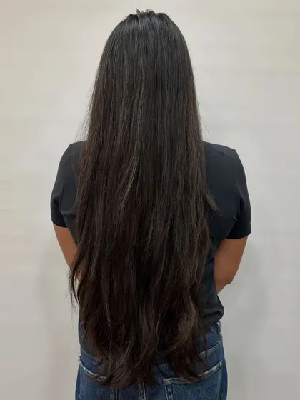 This client was getting her first-ever color. Starting with beautiful virgin hair like this is a clean canvas for a stunning "Cocoa Bean" balayage.