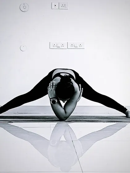 Finding stillness in Prasarita Padottanasana, or Wide-Legged Forward Fold. This pose stretches the hamstrings and inner thighs while calming the mind. It’s a wonderful way to turn inward and let go.