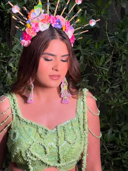A close-up of this incredible carnival look. The makeup is bold yet beautiful, designed to complement the elaborate, light-up floral headpiece.