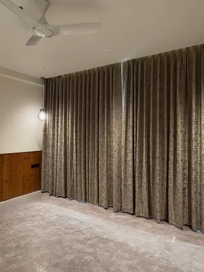 This room is ready for handover, featuring wood wainscoting and full-length curtains that create a cozy and elegant atmosphere.
