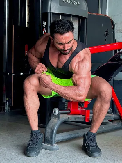 Hitting a bicep pose while seated.