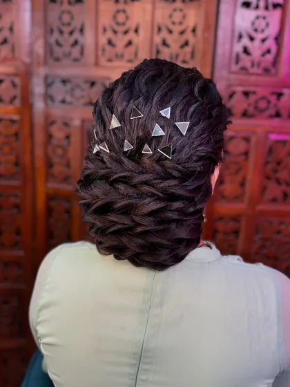 Another angle of the textured bun with mirror accessories, showing the intricate weaving and placement of the details.