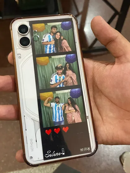 A photo strip tucked perfectly into a clear phone case. It's proof that these memories become a part of your daily life. This one has a custom template for a football-themed event.