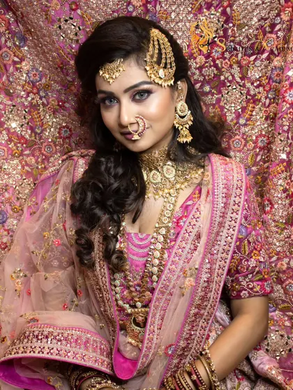 Another beautiful shot of our Muslim bride against an ornate backdrop. The makeup is designed to be both traditional and glamorous, with a focus on flawless skin and defined eyes.
