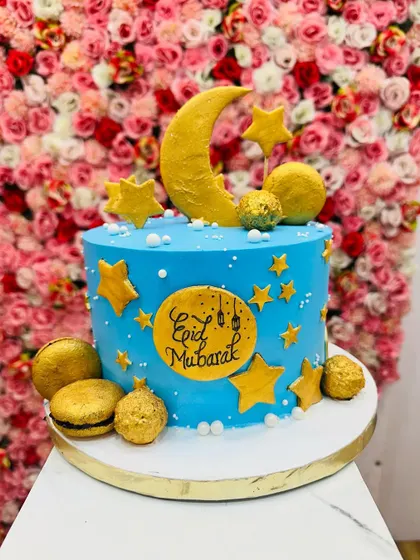An "Eid Mubarak" themed cake to celebrate the festival. The blue cake is decorated with a golden moon and stars, perfect for gifting.