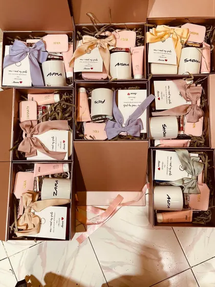 An overhead shot showing a full set of our bridesmaid hampers ready to go. We ensure every detail is perfect, from the personalized tags to the neatly tied bows.