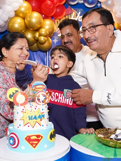 The joy of celebrating with family is priceless. Our venue is designed to bring generations together, creating heartwarming moments like this one around the birthday cake.