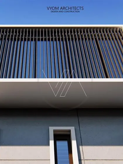 A detail of the upper floor of the NRI Layout project. The vertical fins create a screen that offers privacy and sun shading for the large window, adding a strong geometric element to the facade.