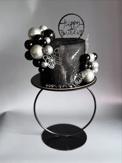 Beauty in black! This striking black and silver cake is designed to catch your attention with its modern, edgy elegance.