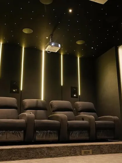 The combination of the starlit ceiling, vertical LED lights, and plush recliners creates a truly luxurious and modern cinematic escape.