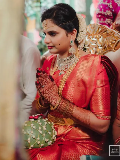 A bride in prayer during her wedding ceremony, a moment of quiet devotion and grace.
