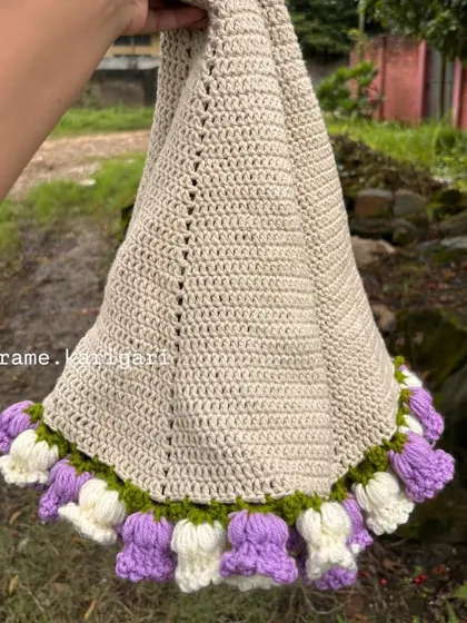 Unfurling the crochet blanket to show its generous size. The main body is stitched with soft, natural-colored cotton, perfect for a baby's sensitive skin.