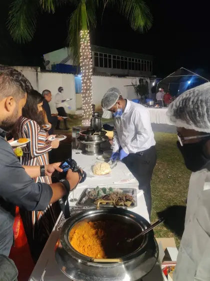 Our staff serving guests at a wedding buffet line. We ensure every guest is attended to with professional and hygienic service, allowing you to enjoy your celebration.
