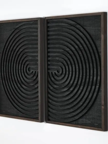 A modern two-piece geometric set in black, featuring an abstract labyrinth design. Hung together, they create a single, mesmerizing artwork ideal for a headboard or large feature wall.