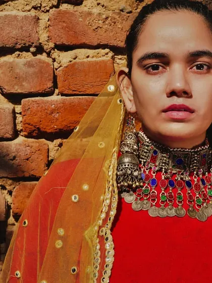 A direct portrait from the jewelry shoot, showcasing a layered necklace set with colorful stones and coins. The styling is bold and confident, celebrating the beauty of traditional Indian craftsmanship.