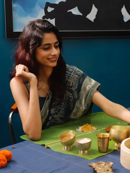 The smile says it all. Enjoying a Sadya is a moment of pure happiness. The traditional setting with the banana leaf and brassware makes the experience even more special and authentic.