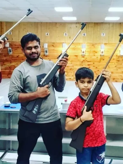 A family poses with their air rifles after a fun session at our range. Our guest shooting is open to ages 11 and up, making it a safe and exciting activity for the whole family.