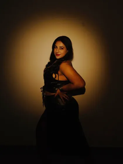 A moody, artistic shot using a spotlight. This photo plays with light and shadow to create a dramatic and captivating portrait.