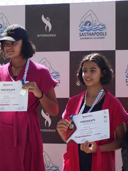 The joy of victory is clear on the faces of these young swimming champions.