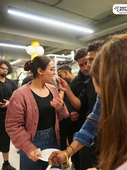 Sharing cake and celebrating together. A candid moment from our anniversary party, showing the close-knit community we are.