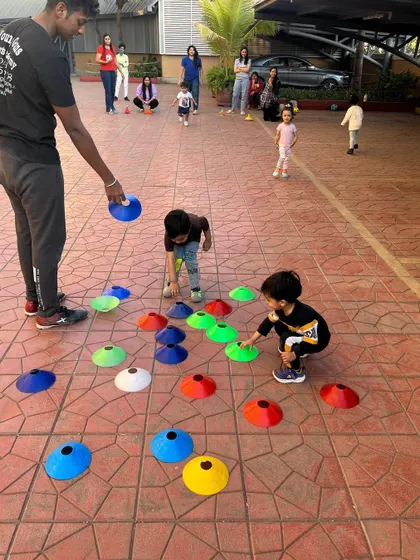 Toddlers learn about colors and coordination by picking up cones. We turn learning into a game to keep our youngest players engaged.