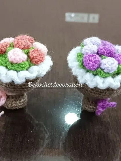 Two mini bouquet baskets, one with pink and red roses and the other with purple roses. These are a lovely alternative to traditional pots.